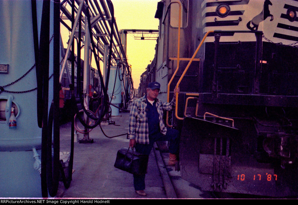 An unidentified crewman poses before boarding his train